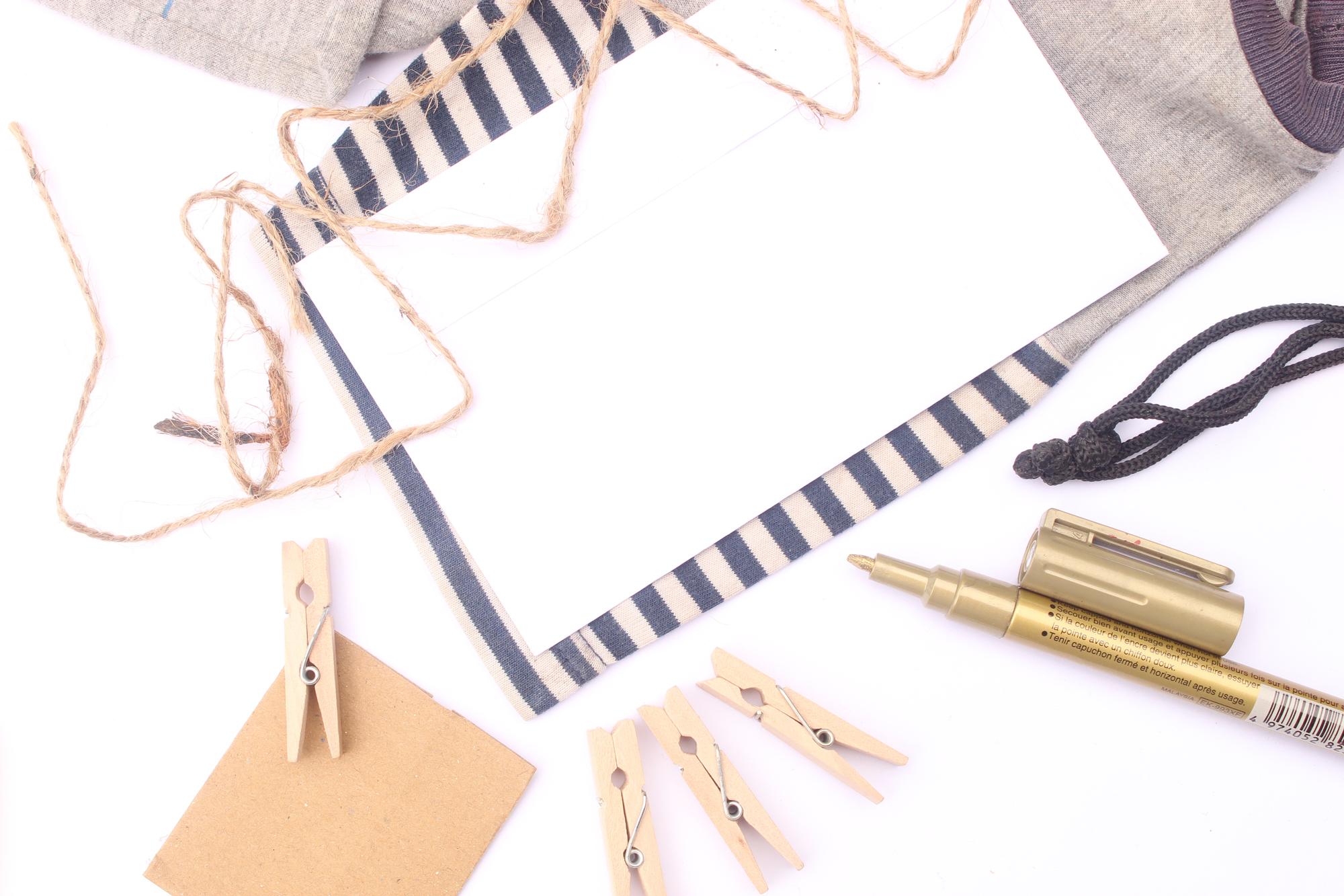 Flatlay of threads, needles and pattern sketches